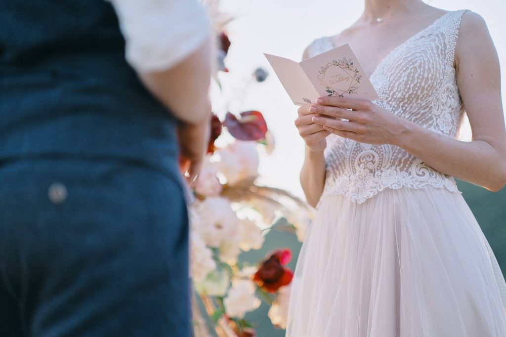 The bride reads a wedding speech to groom. Beautiful moment from a wedding ceremony in nature.