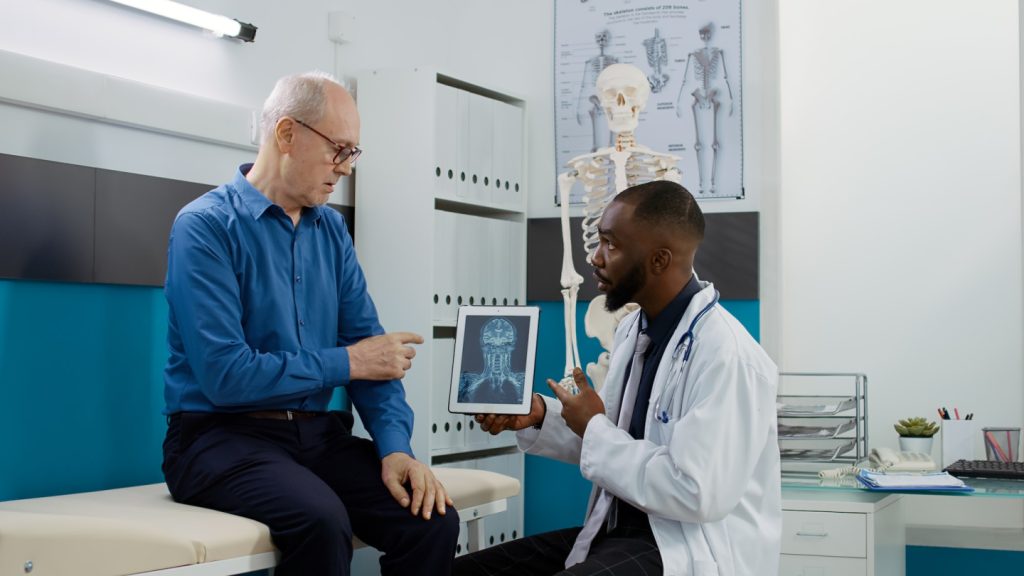 Medic physician explaining x ray scan results to patient