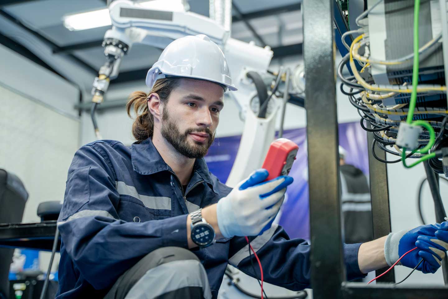 Electrician engineer work tester measuring voltage and current of power electric line.