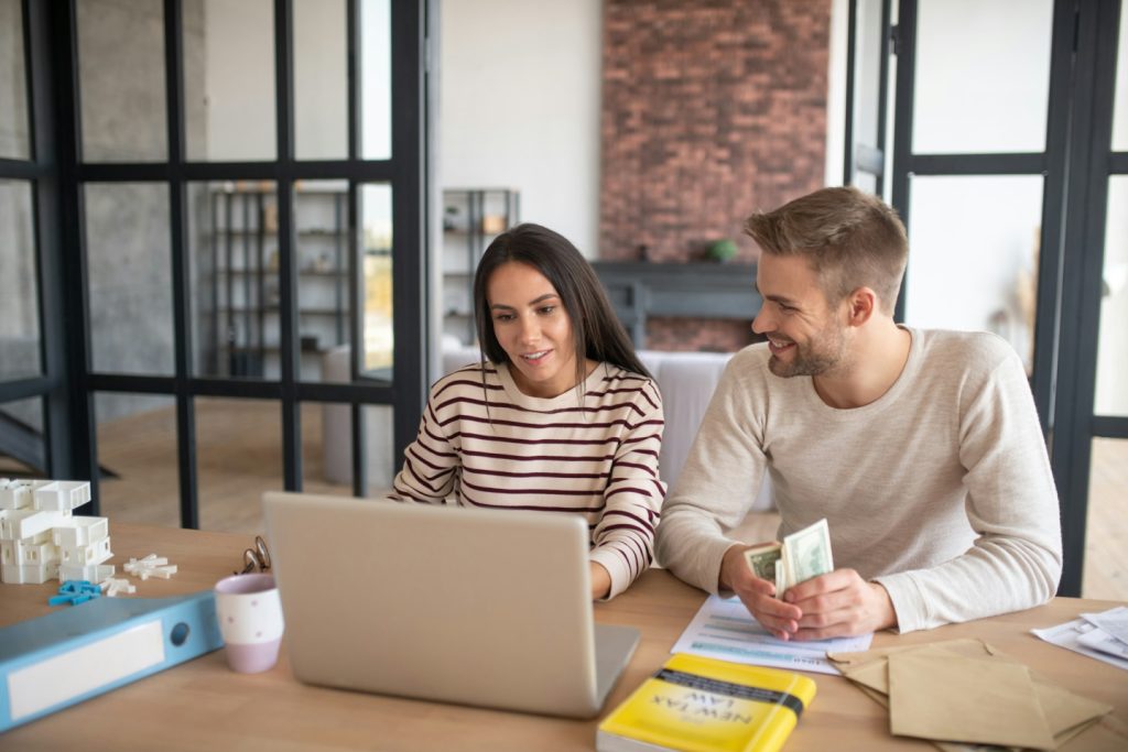 Husband looking at wife after counting profits from business