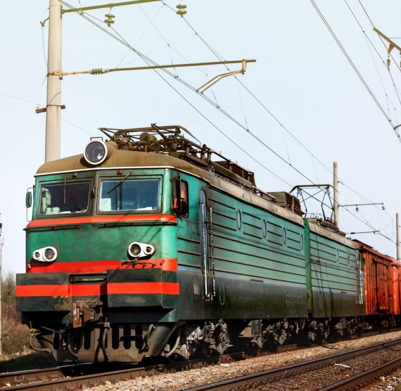 front of old train crossing railway and transporting goods carriage, transportation concept