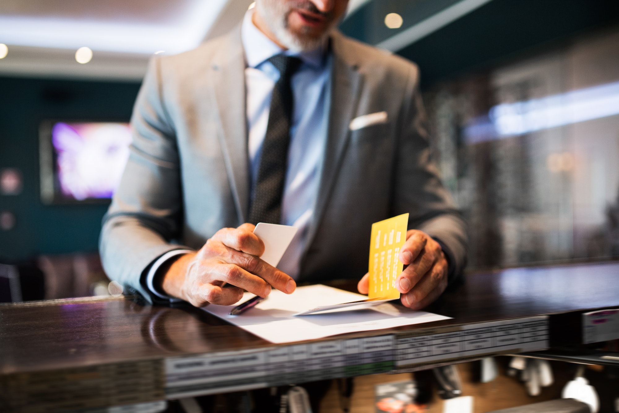 Mature businessman at hotel reception.