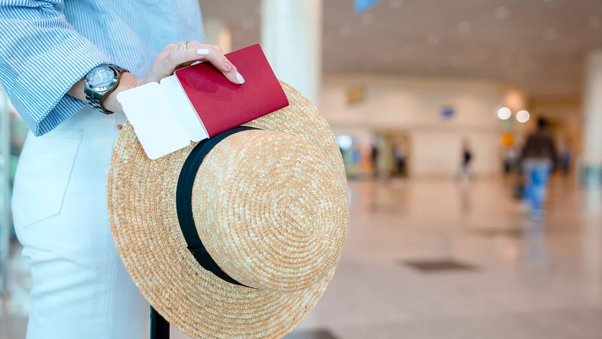closeup of man holding passports and boarding pass