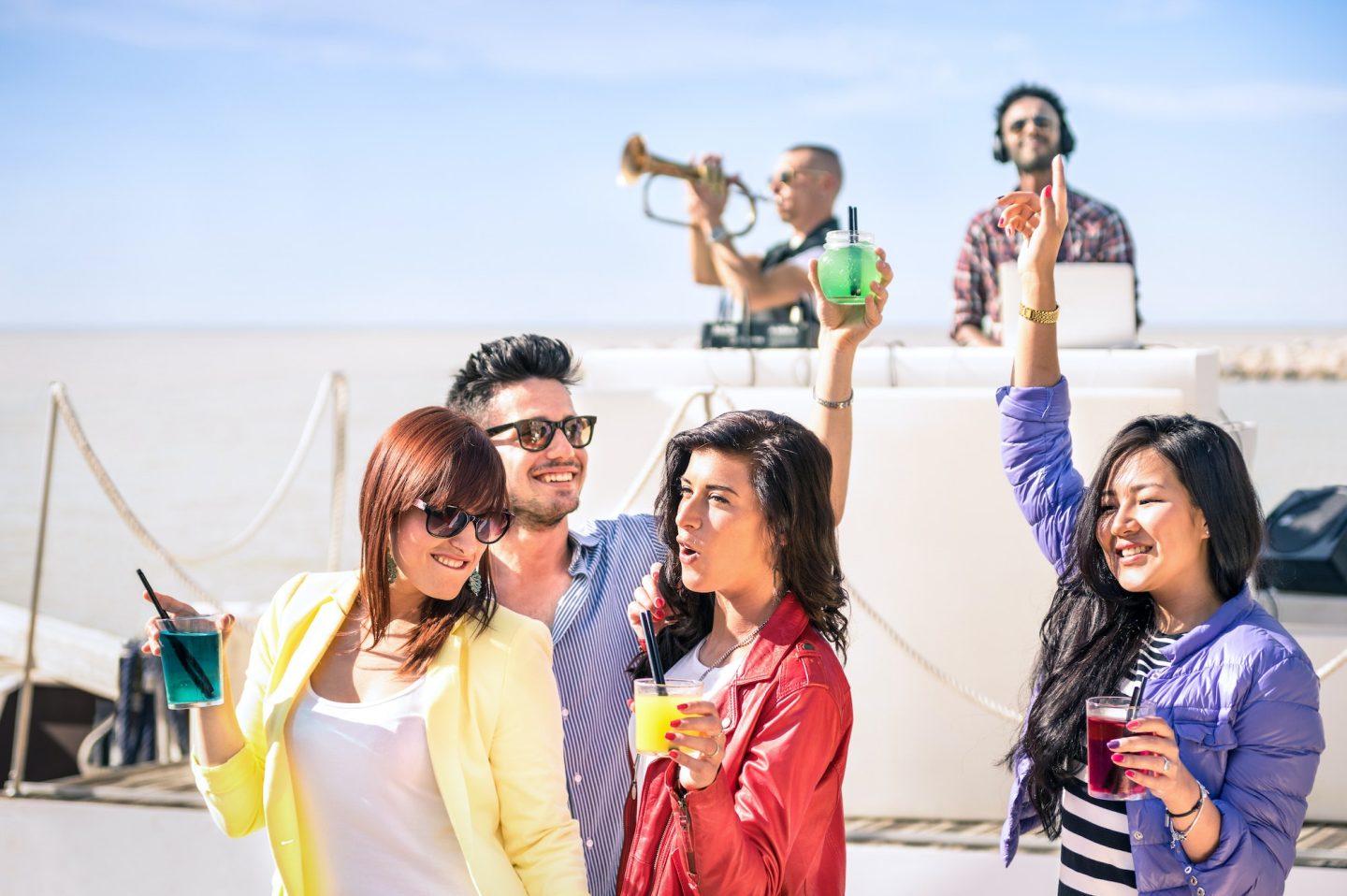 Funky people dancing music and having fun together at beach rave afterhour party