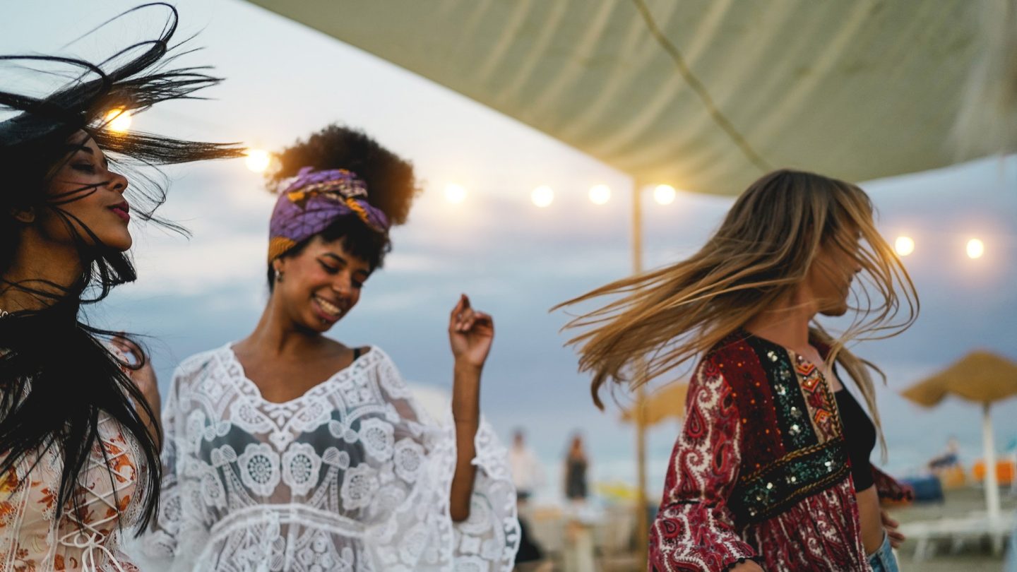 Multiracial friends having fun dancing together outdoor at beach party