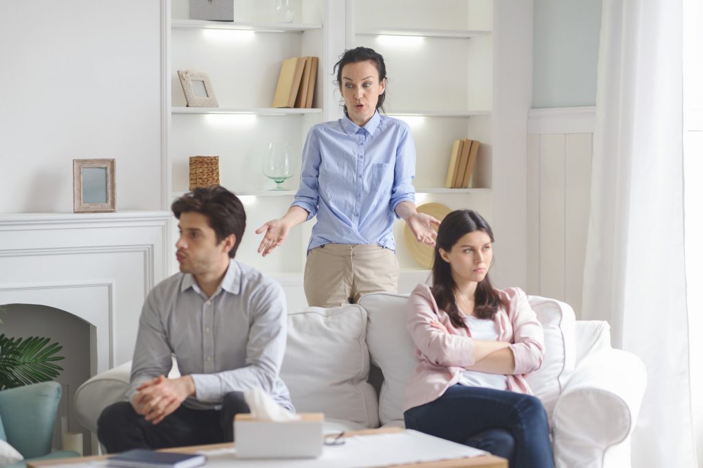 Professional therapist working with fighting young couple