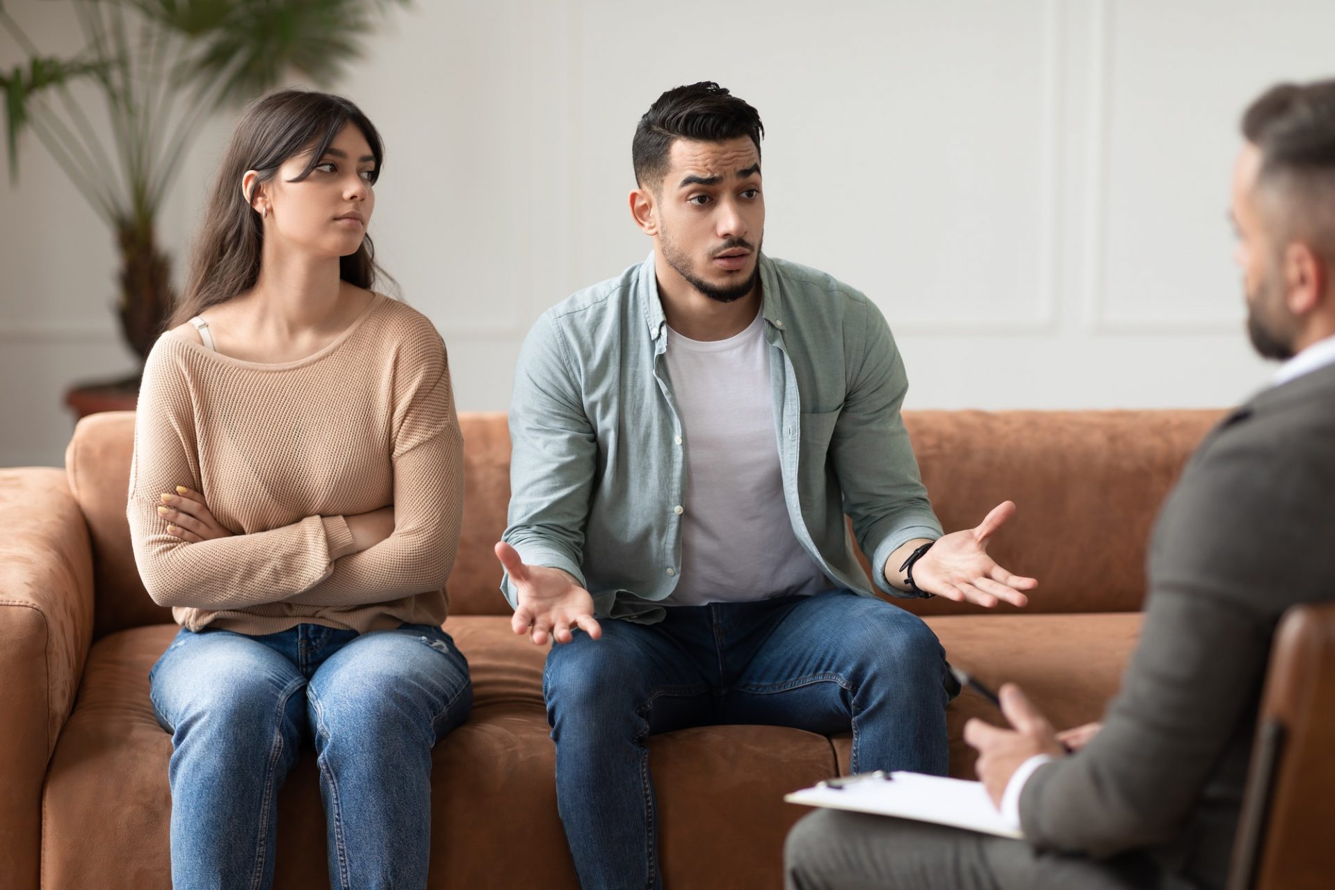 Couple talking at therapy session with male therapist