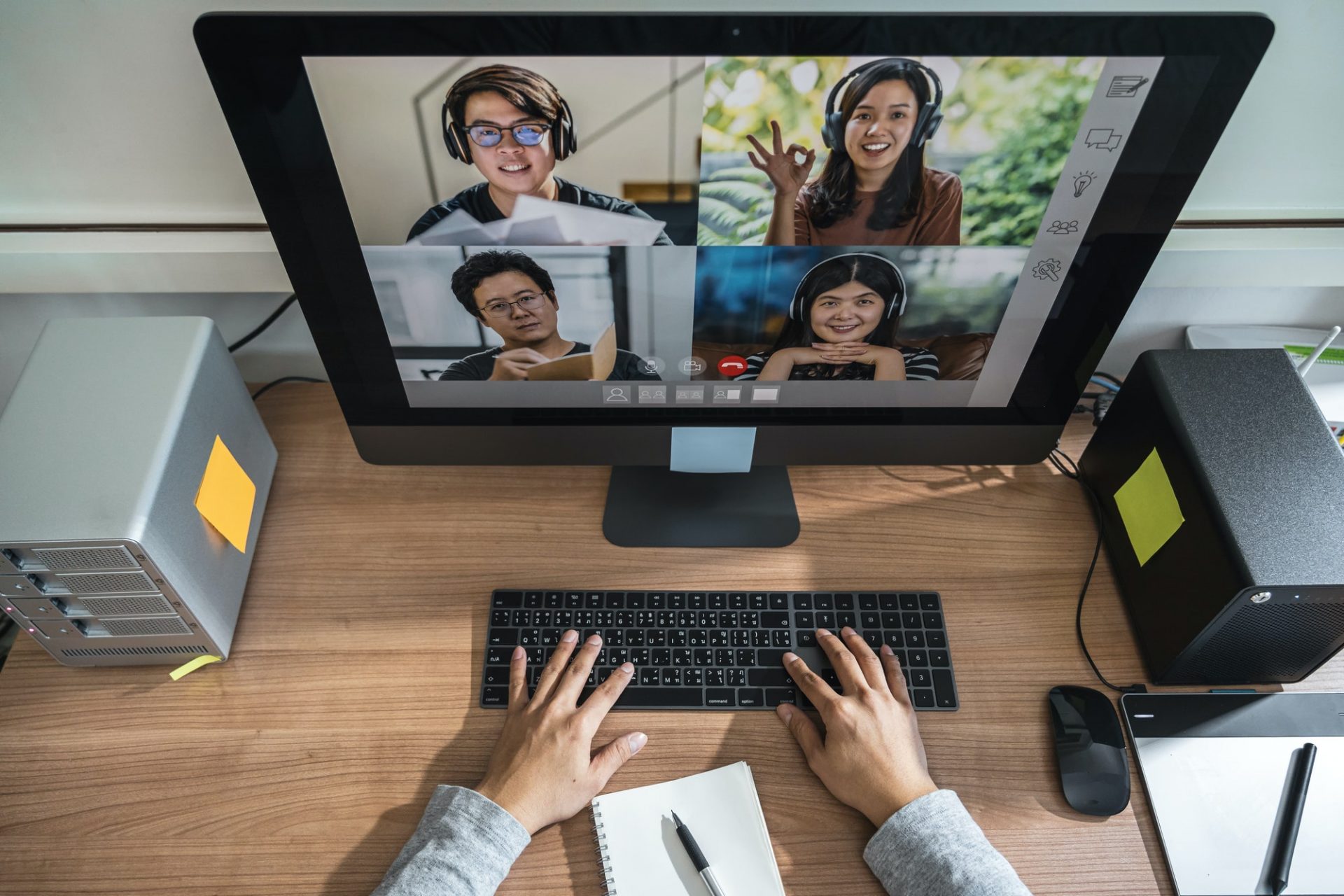Top view of Asian Business man hand working with teamwork colleague in video conference