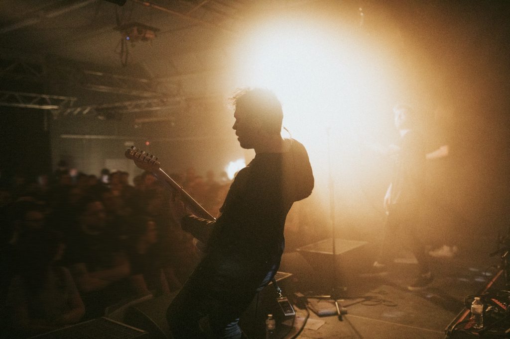 Guitarist playing an electric guitar in a concert