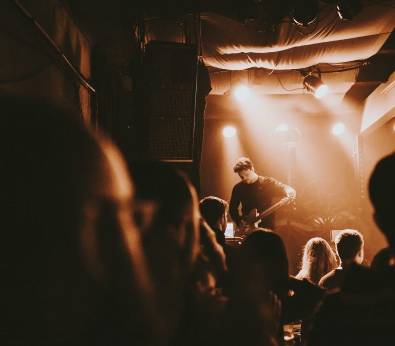 Guitarist playing an electric guitar in a concert