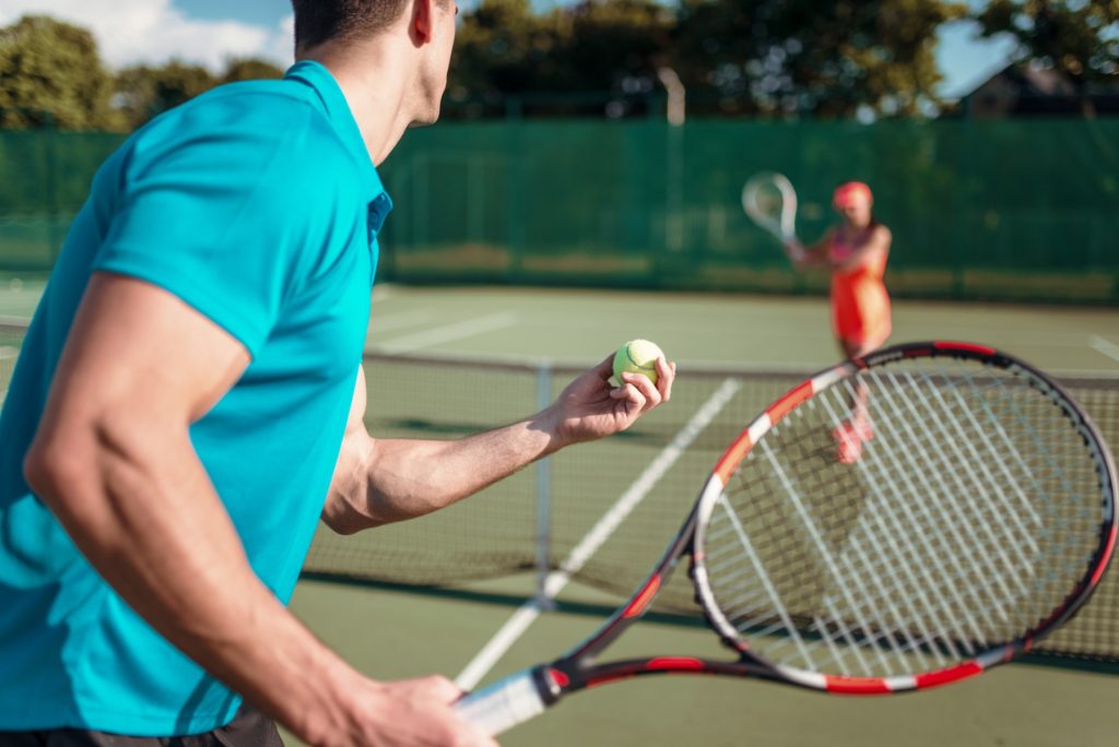 Players with rackets on outdoor tennis court
