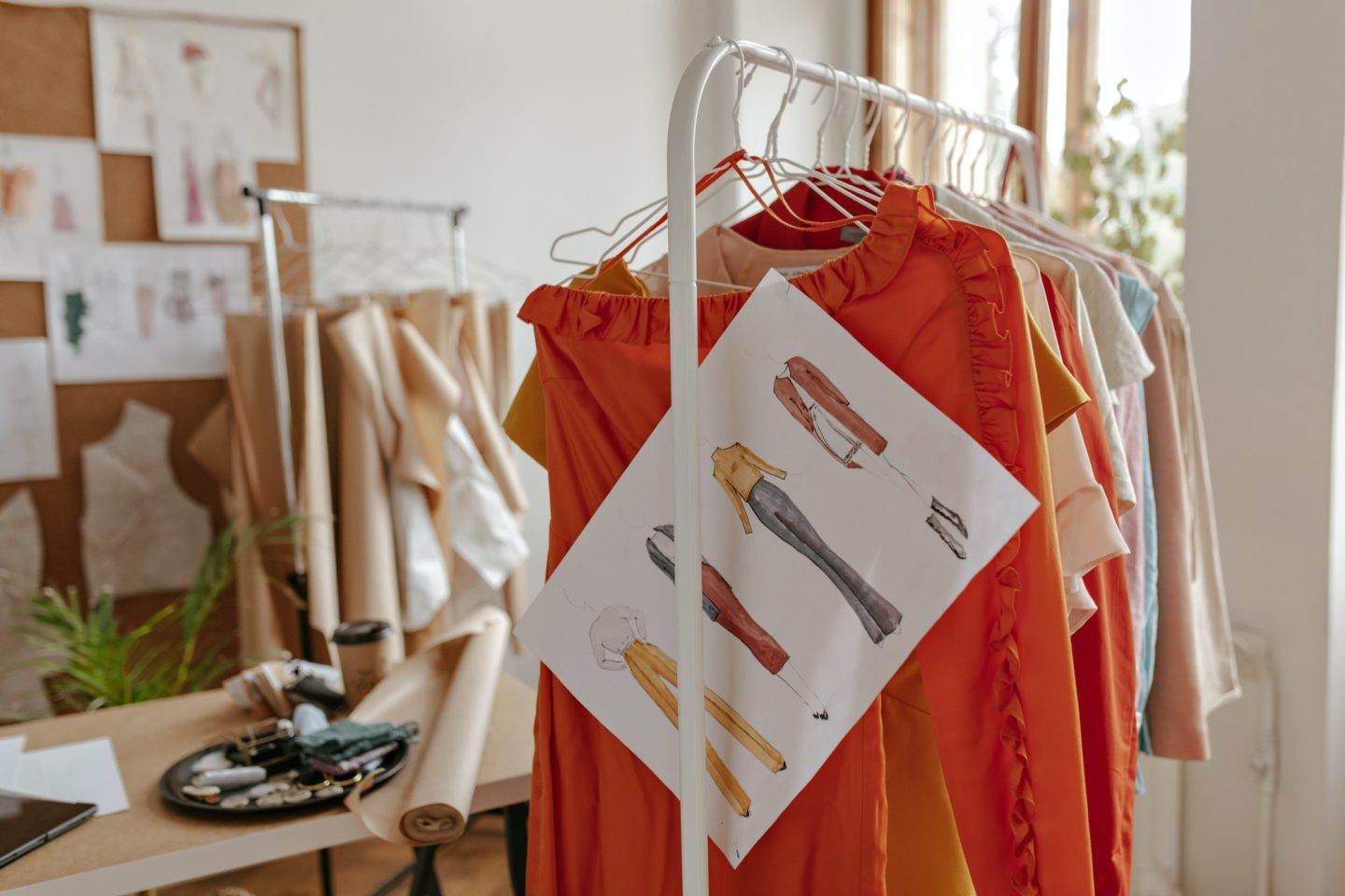 Snapshot of colorful summer stylish outfits and painted garments on hangers in dressing room. Photo