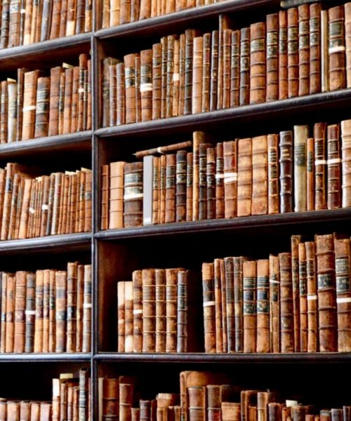 Hundreds of old books in the library of Trinity College in Dublin, Ireland, with a ladder to reach.