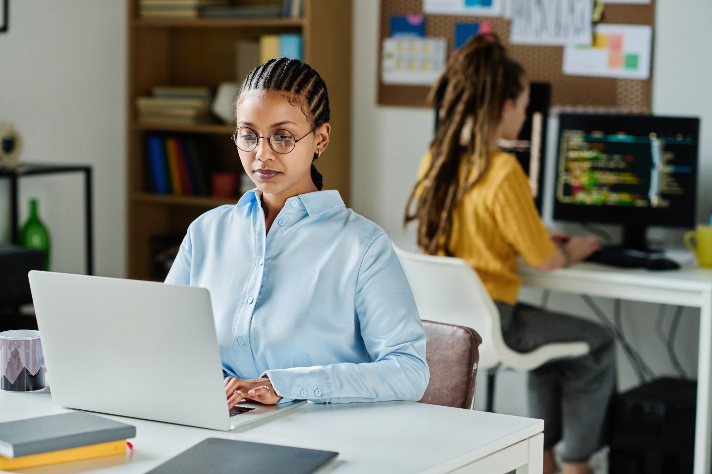 Female programmer working on laptop in office