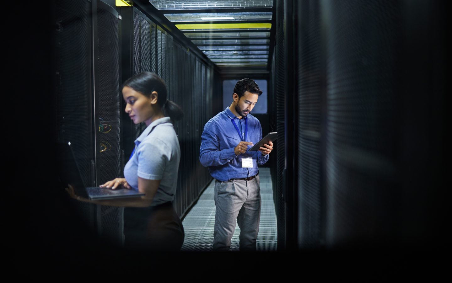 Man, woman or technology in server room, IT engineering or software programming for cybersecurity,