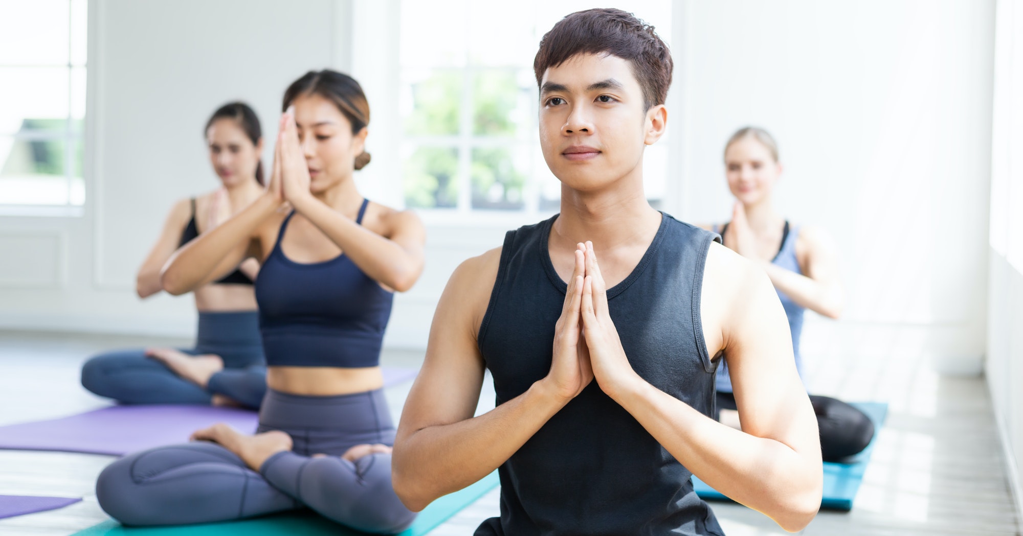 Group of people meditating in yoga class
