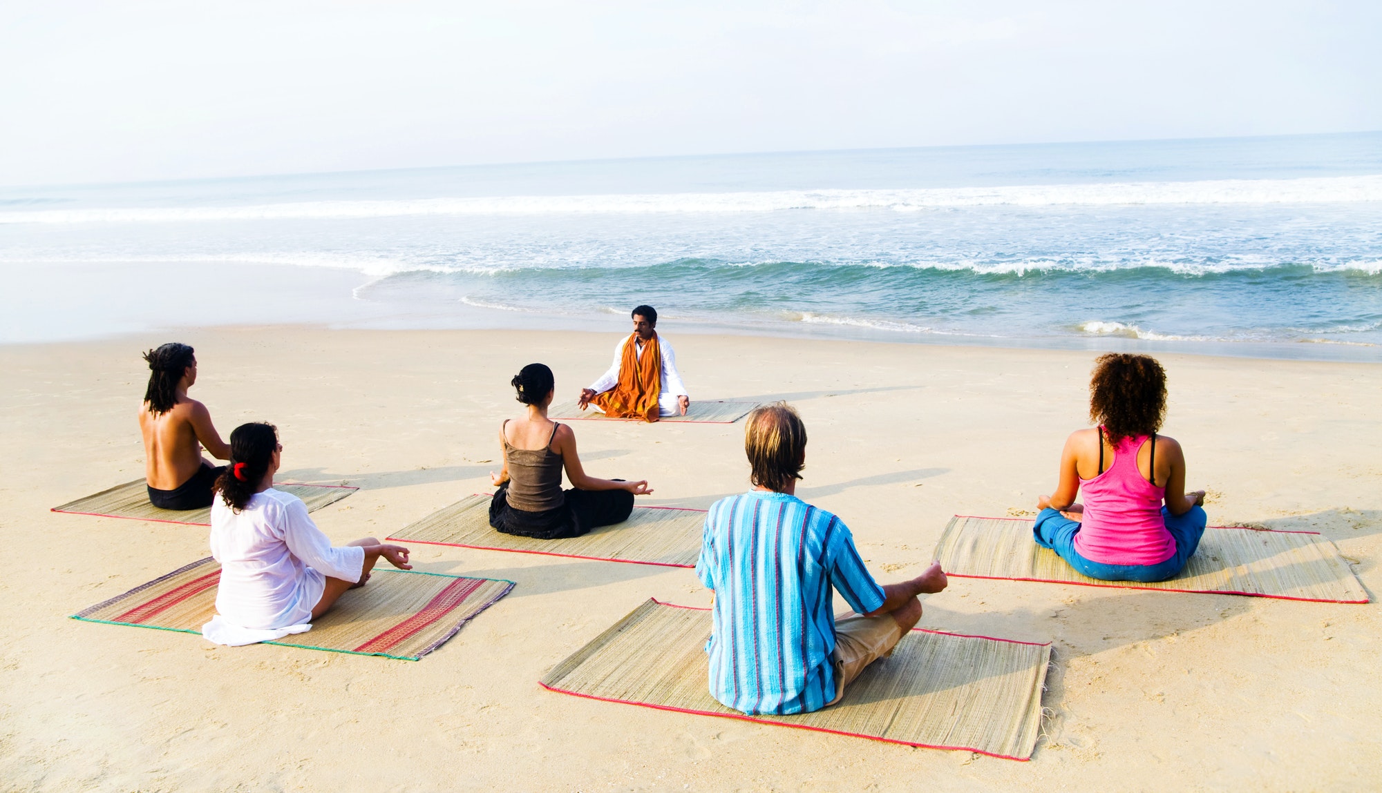 Healthy yoga class on the beach