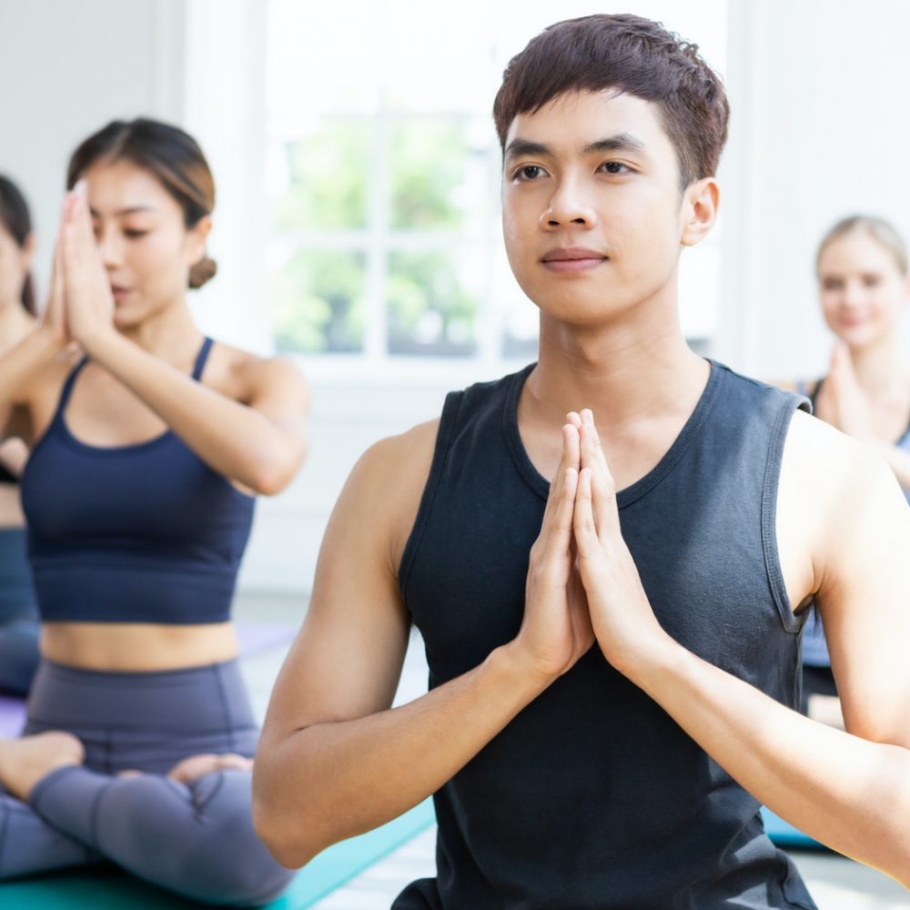 Group of people meditating in yoga class