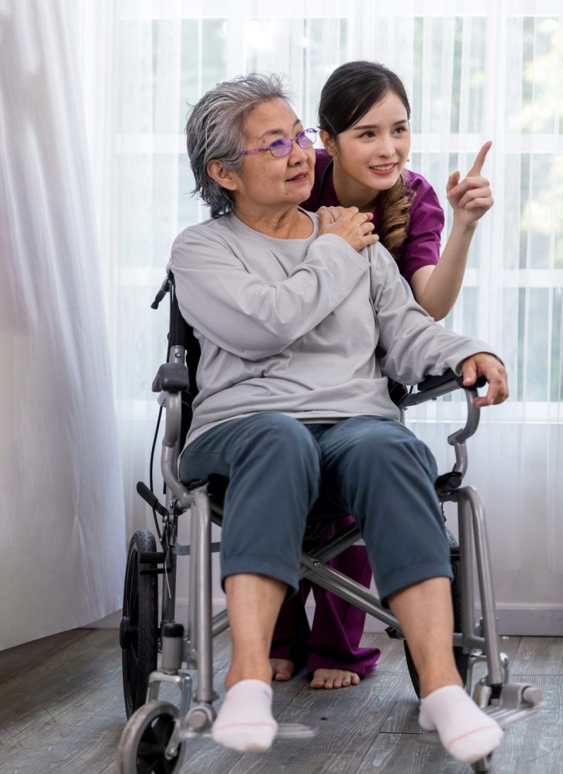 Caregiver nurse take care a Senior patient sit on wheelchair. Nurse helping senior Woman